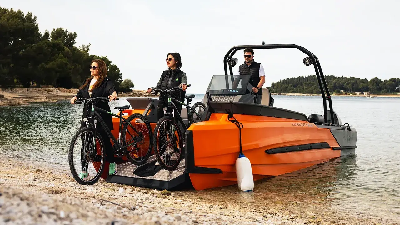 Korkyra 650 Pro varada en la orilla con bicicletas sobre la plataforma de carga delantera